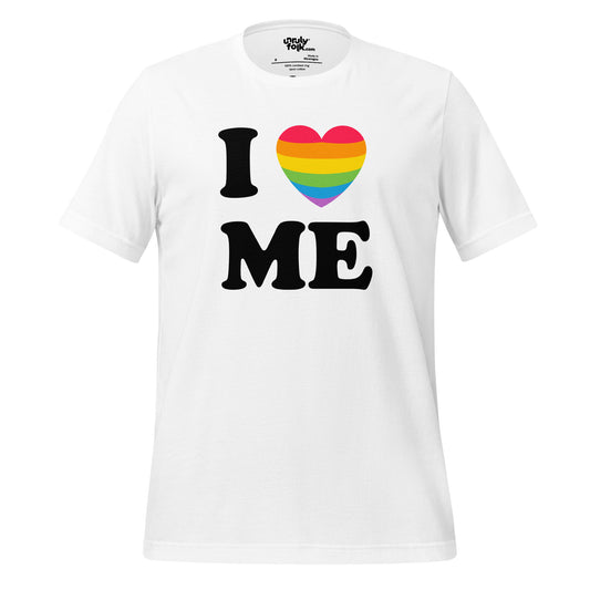 The image is a white t-shirt with text that says "I LOVE ME" - a heart with the pride flag takes the place of the word love. Unruly Folk brand. 